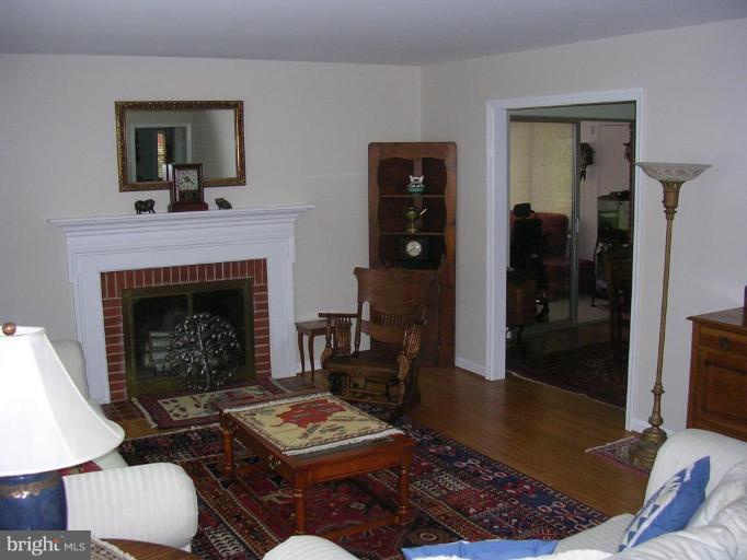 1303 Ruppert Road Silver Spring, MD 20903 - Photo 10 of 11 a living room with furniture and a fireplace
