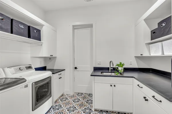 a kitchen with stainless steel appliances white cabinets and a stove top oven