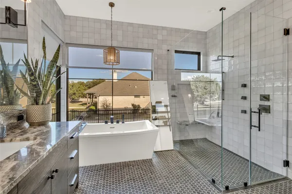 a bathroom with a sink a mirror and shower
