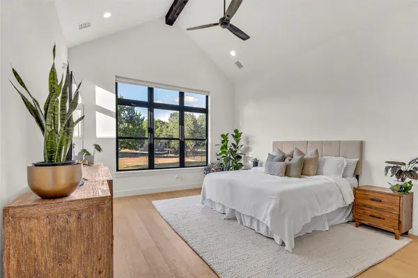 a bedroom with a bed and a potted plant