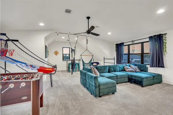 a living room with furniture a ceiling fan and a window