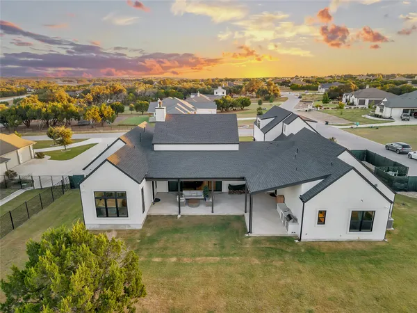 a aerial view of a house next to a lake view