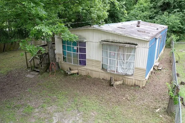 a backyard of a house with barbeque oven