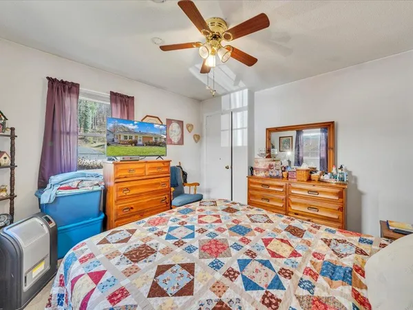 a bedroom with a bed and a chandelier