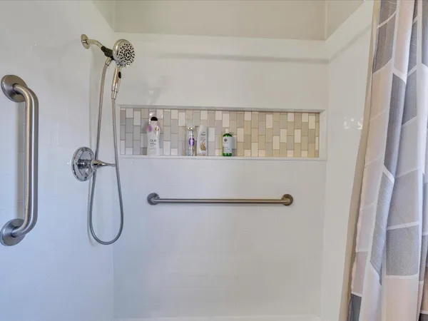 a bathroom with a bath tub with a shower