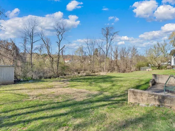 a backyard of a house with table and chairs