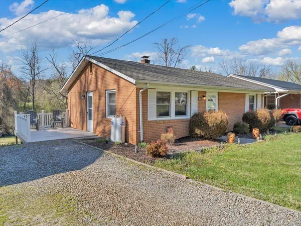 a front view of house with yard outdoor seating and barbeque oven