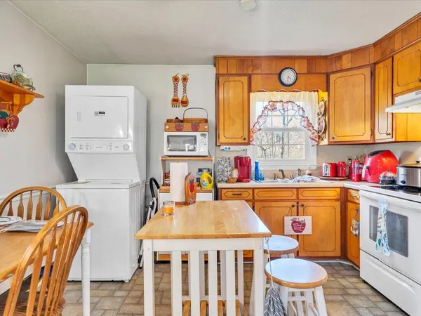 a kitchen with a refrigerator and a stove top oven