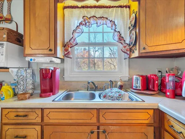 a kitchen with an oven a cabinets and a sink