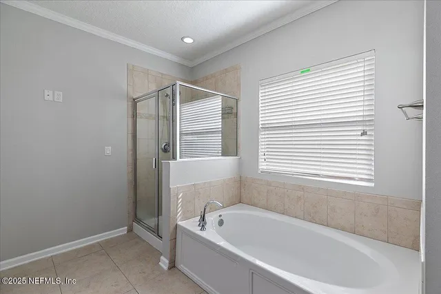 a white bath tub sitting in a bathroom next to a window