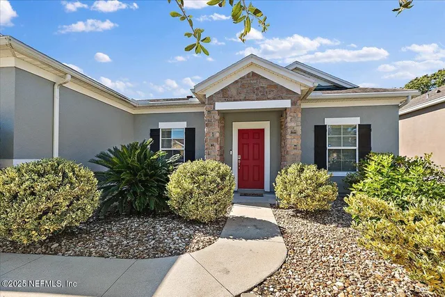 a front view of a house with garden