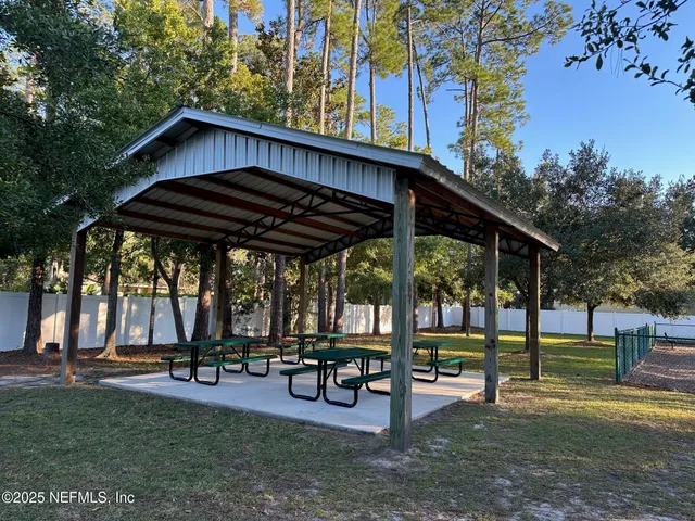 a view of sitting area with chairs and table under an umbrella