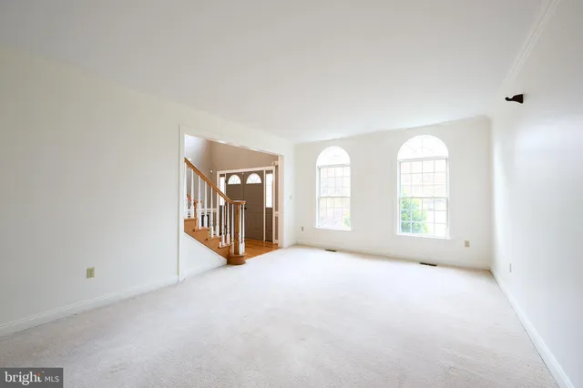 a large kitchen with stainless steel appliances kitchen island granite countertop a refrigerator and a sink