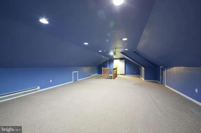 an aerial view of residential house with pool and garden