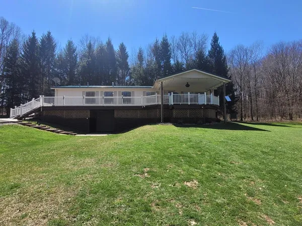 a view of a big yard with a house in the background