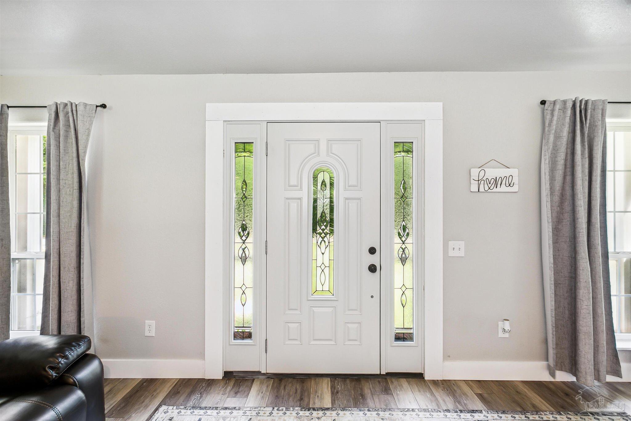7260 Morrell Road Milton, FL 32583 - Photo 13 of 33 a view of an empty room with wooden floor and a window