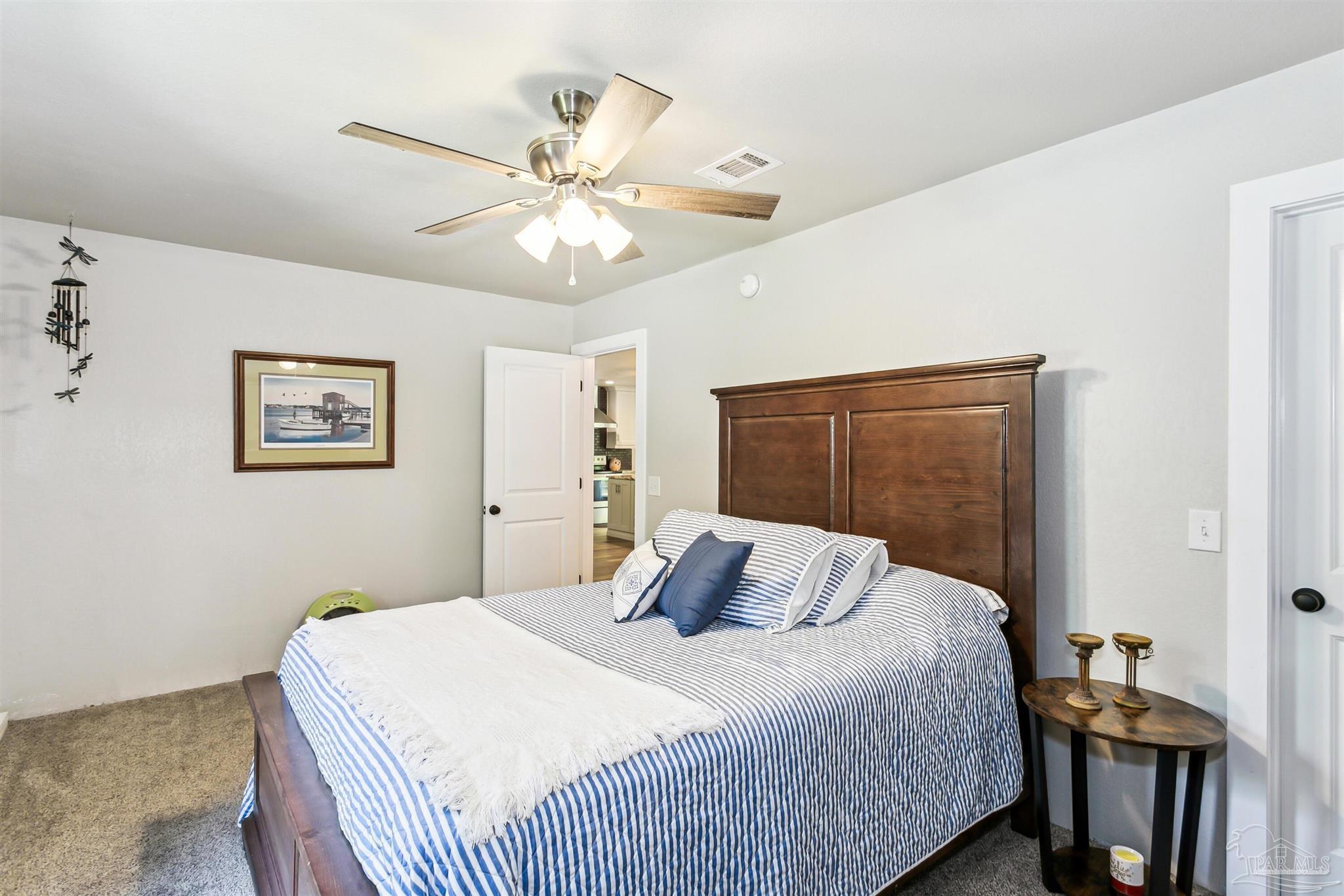 7260 Morrell Road Milton, FL 32583 - Photo 20 of 33 a bedroom with a bed and a chandelier