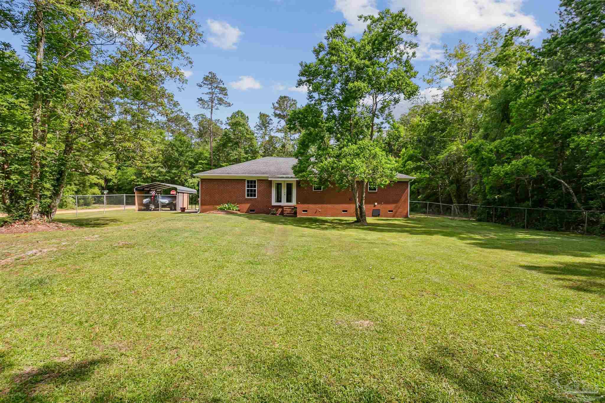 7260 Morrell Road Milton, FL 32583 - Photo 2 of 33 a house view with swimming pool in front of it