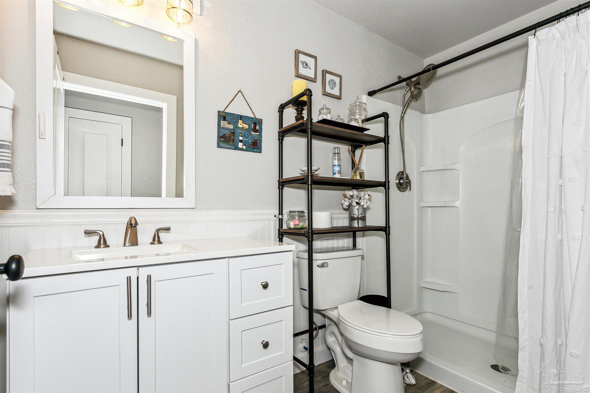 7260 Morrell Road Milton, FL 32583 - Photo 21 of 33 a bathroom with a sink toilet vanity and a mirror