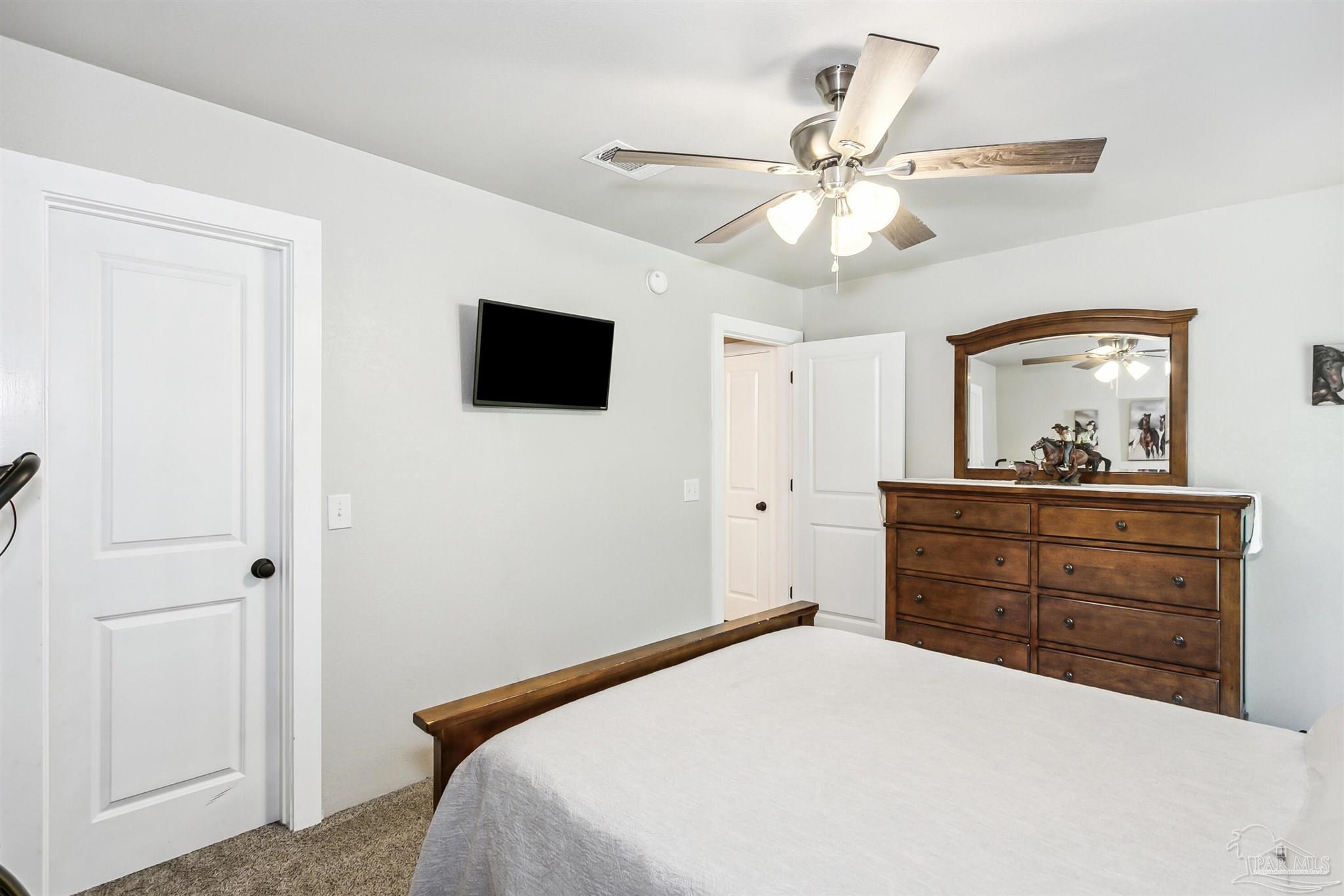 7260 Morrell Road Milton, FL 32583 - Photo 22 of 33 a bedroom with a bed and a flat screen tv