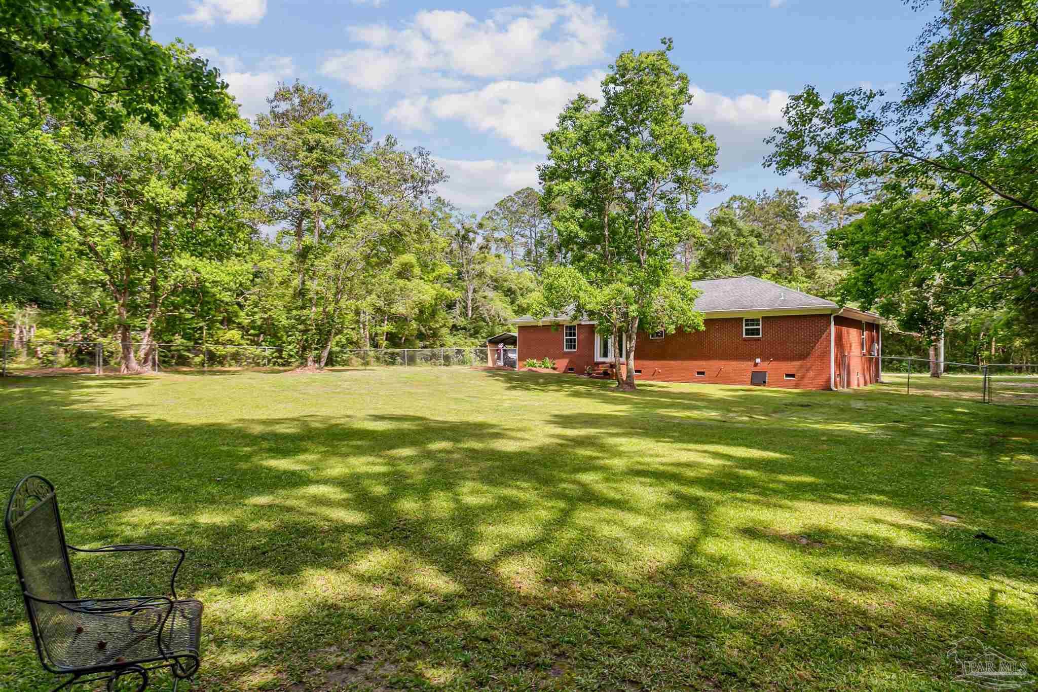 7260 Morrell Road Milton, FL 32583 - Photo 26 of 33 a view of outdoor space with garden and trees