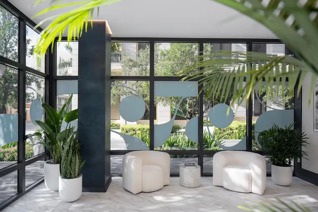 a two chairs sitting in front of yellow house