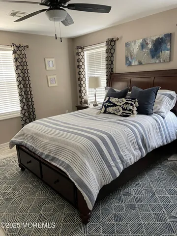 a bedroom with bed and window