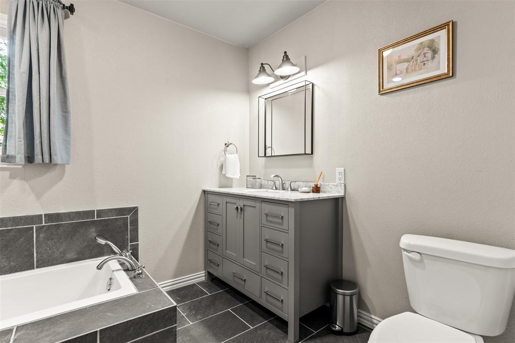 3116 Alexander Avenue Waco, TX 76708 - Photo 26 of 40 a bathroom with a sink a toilet and mirror