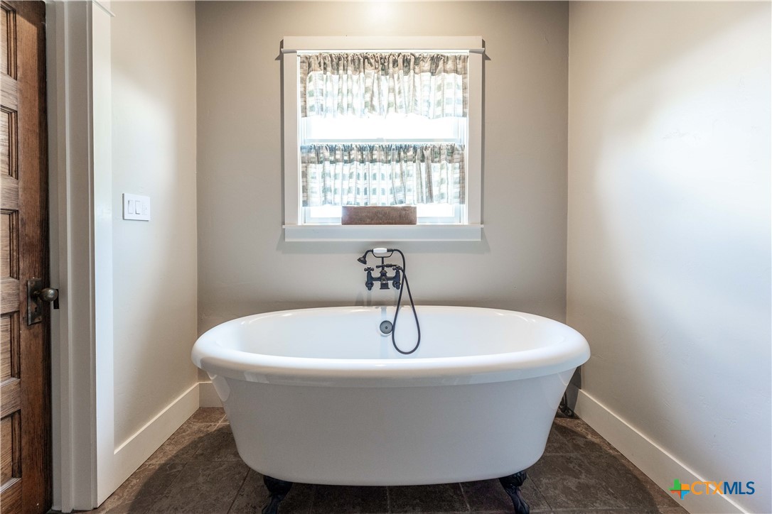 1440 West Klein Road New Braunfels, TX 78130 - Photo 19 of 42 a white bath tub sitting in a bathroom
