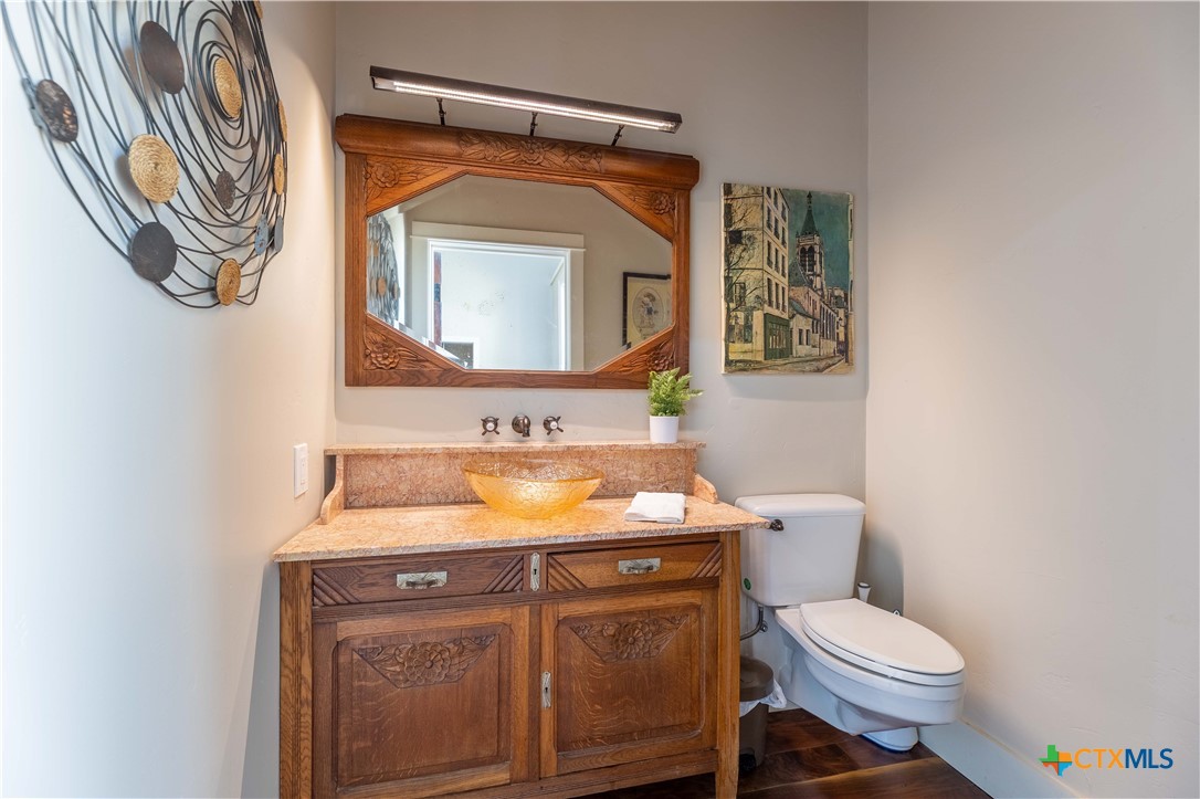 1440 West Klein Road New Braunfels, TX 78130 - Photo 25 of 42 a bathroom with a toilet a sink and mirror