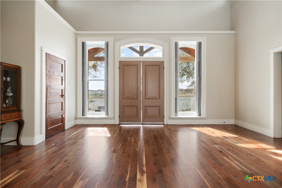 1440 West Klein Road New Braunfels, TX 78130 - Photo 5 of 42 wooden floor chandelier and windows in a room
