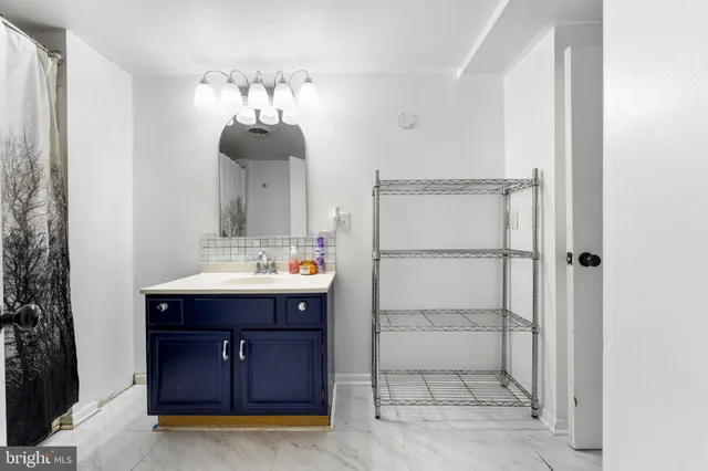 a bathroom with a sink vanity and mirror