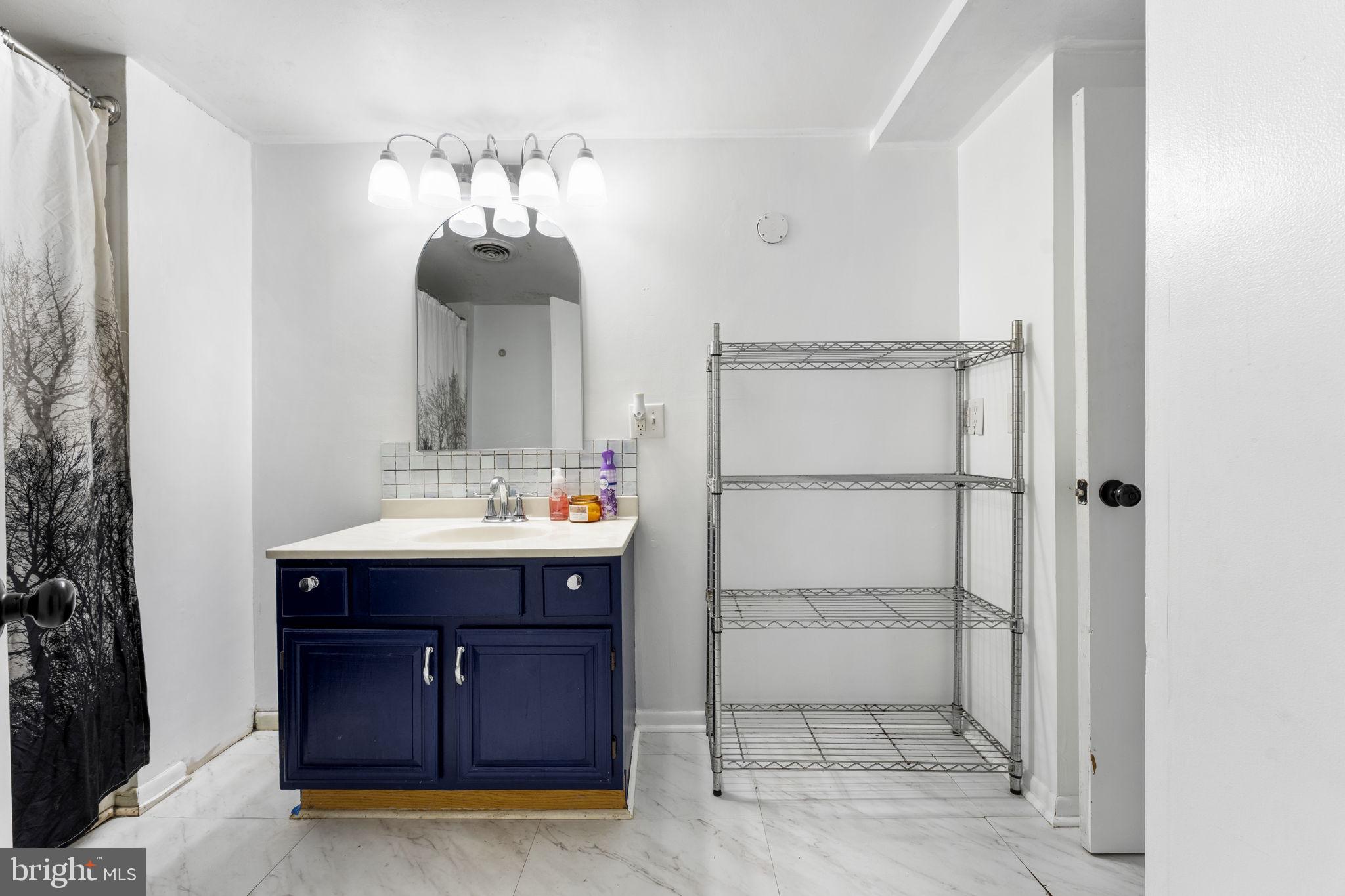 5087 Wheatleys Pond Road Smyrna, DE 19977 - Photo 11 of 36 a bathroom with a sink vanity and mirror