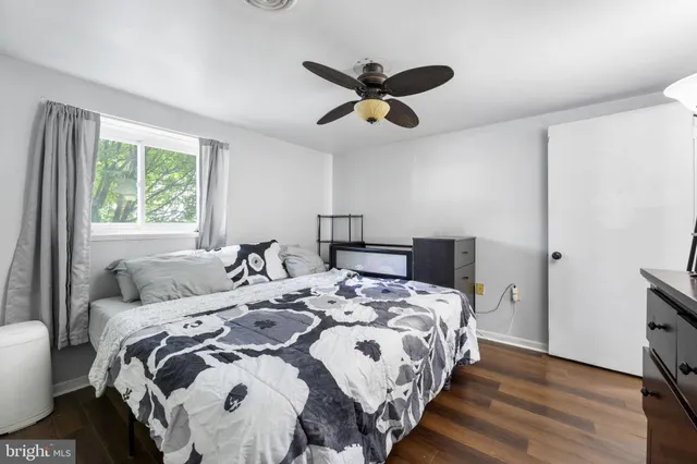 a bedroom with a bed and a large window