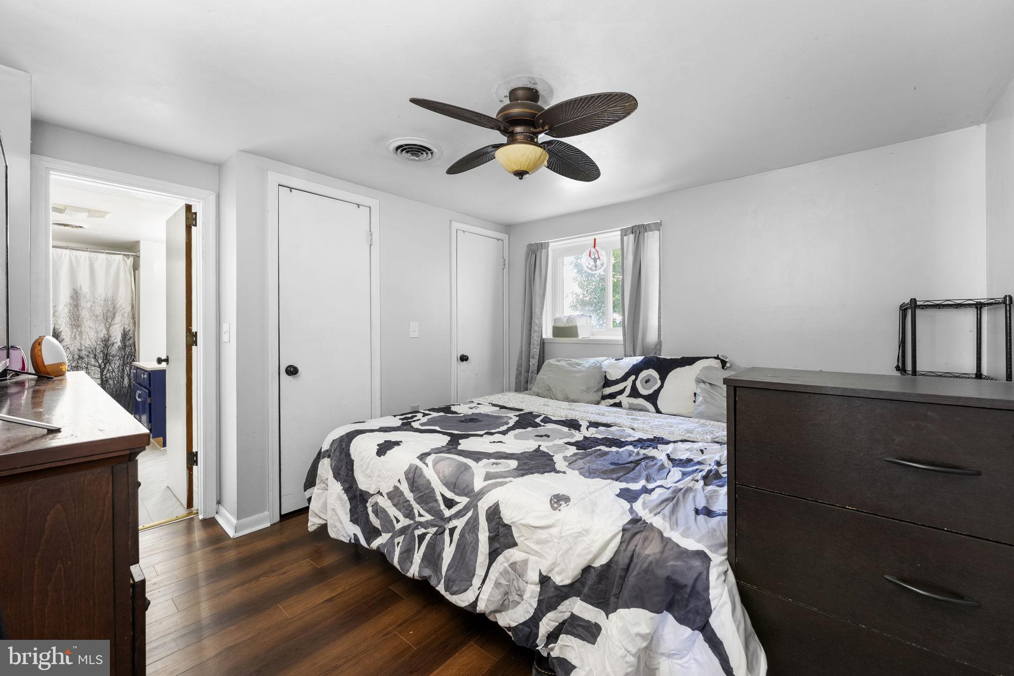 5087 Wheatleys Pond Road Smyrna, DE 19977 - Photo 14 of 36 a bedroom with a bed and a chandelier