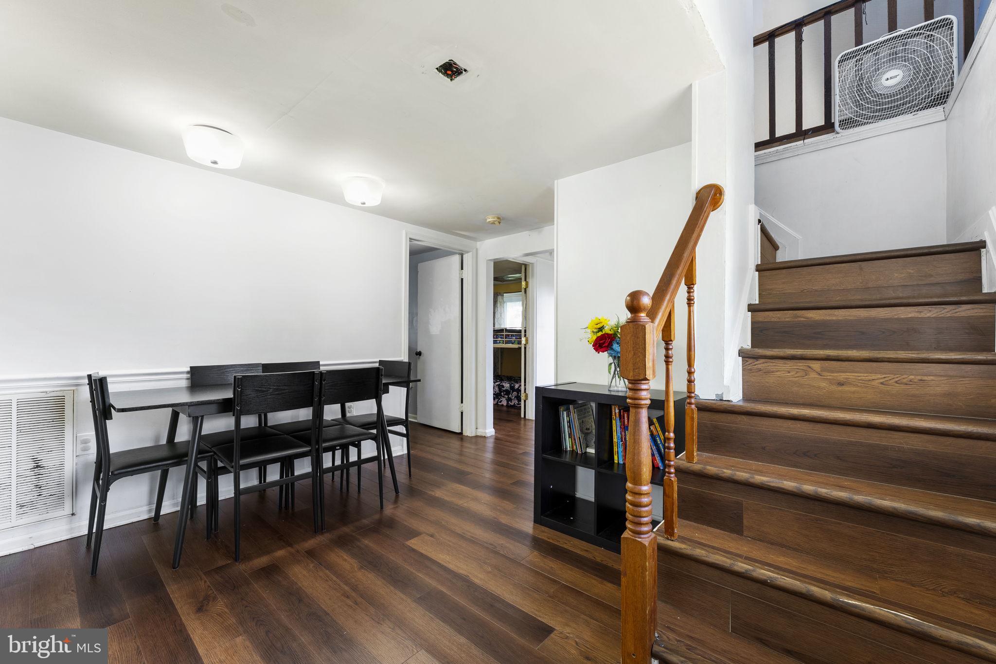5087 Wheatleys Pond Road Smyrna, DE 19977 - Photo 16 of 36 a view of a dining room with furniture and wooden floor