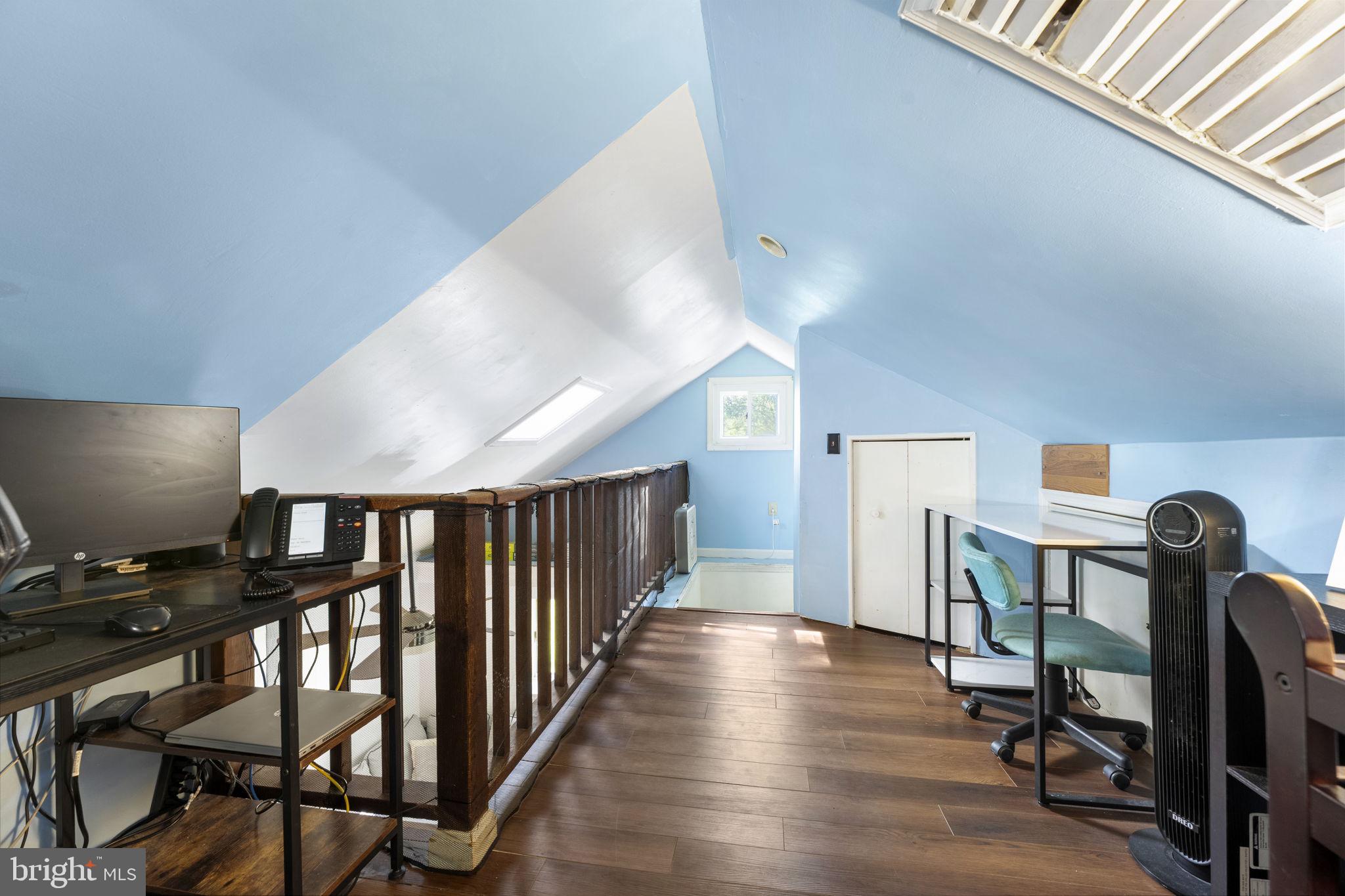 5087 Wheatleys Pond Road Smyrna, DE 19977 - Photo 17 of 36 a view of a hallway with workspace and wooden floor