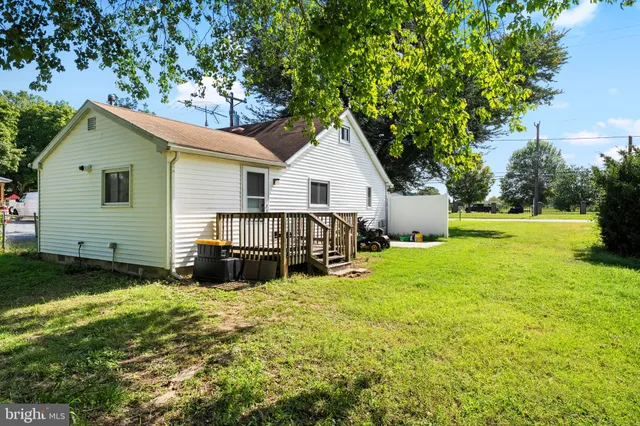 a view of a house with a yard and sitting area