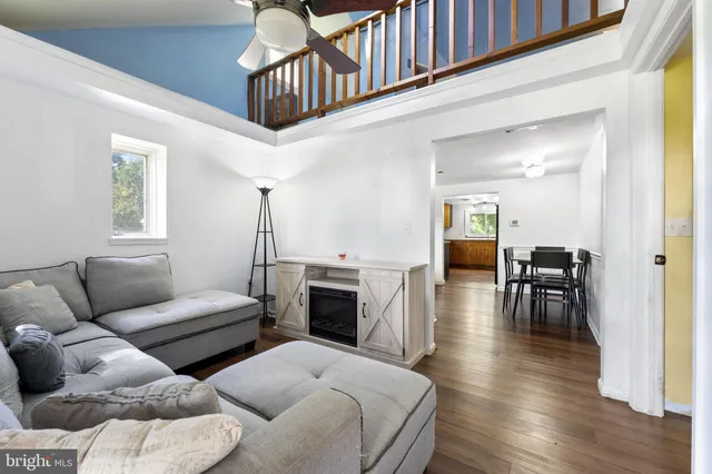 a living room with furniture and a wooden floor