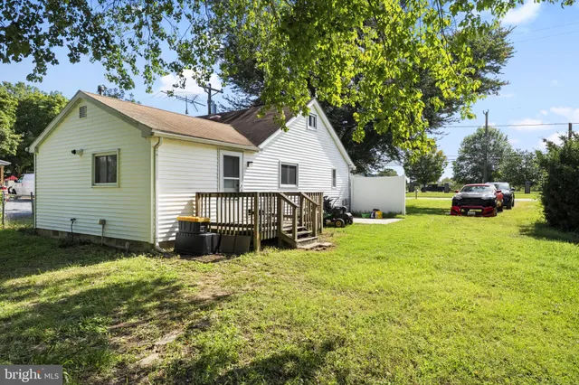a view of a house with a yard and sitting area