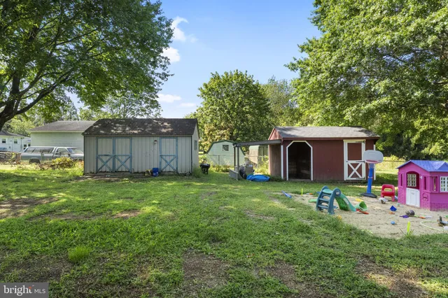 a view of yard with swimming pool and trees