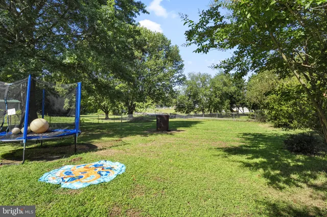 a swimming pool with outdoor seating and yard
