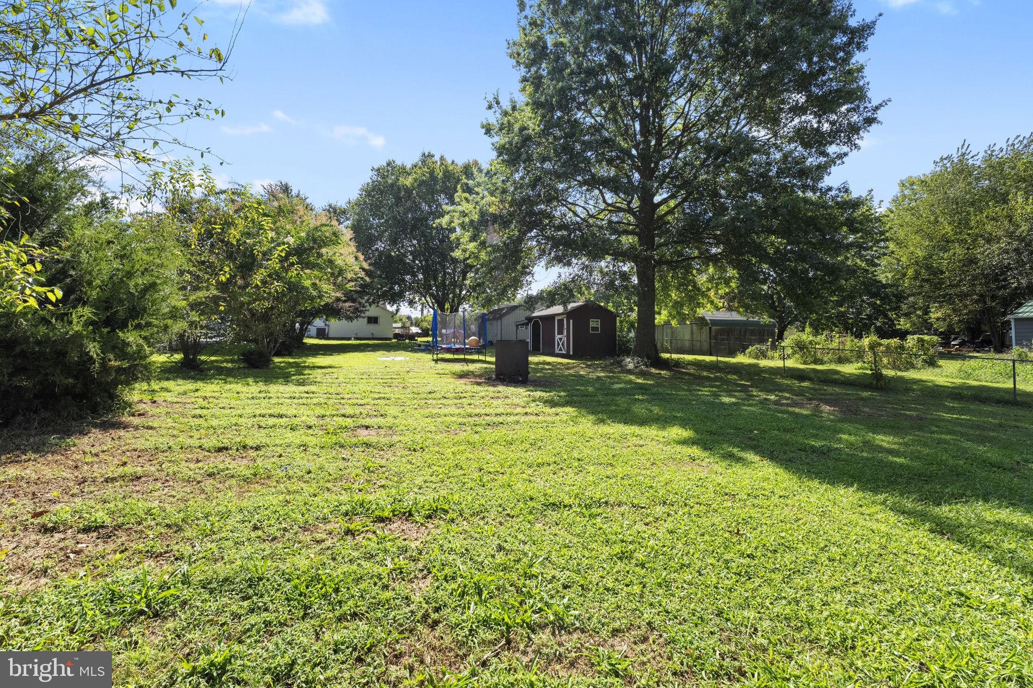 5087 Wheatleys Pond Road Smyrna, DE 19977 - Photo 29 of 36 a swimming pool with outdoor seating and yard