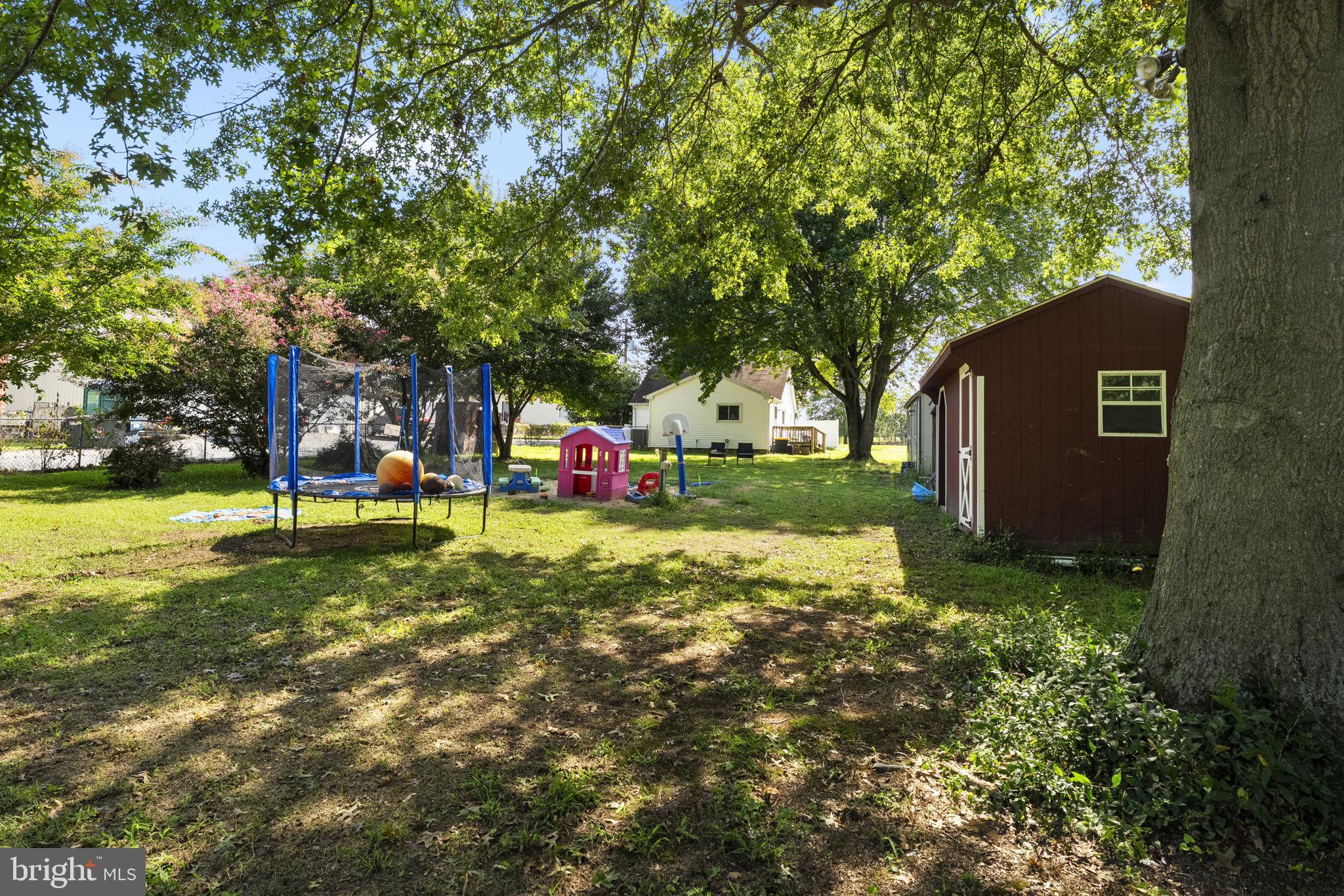 5087 Wheatleys Pond Road Smyrna, DE 19977 - Photo 31 of 36 a view of a tree in front of a house with a big yard