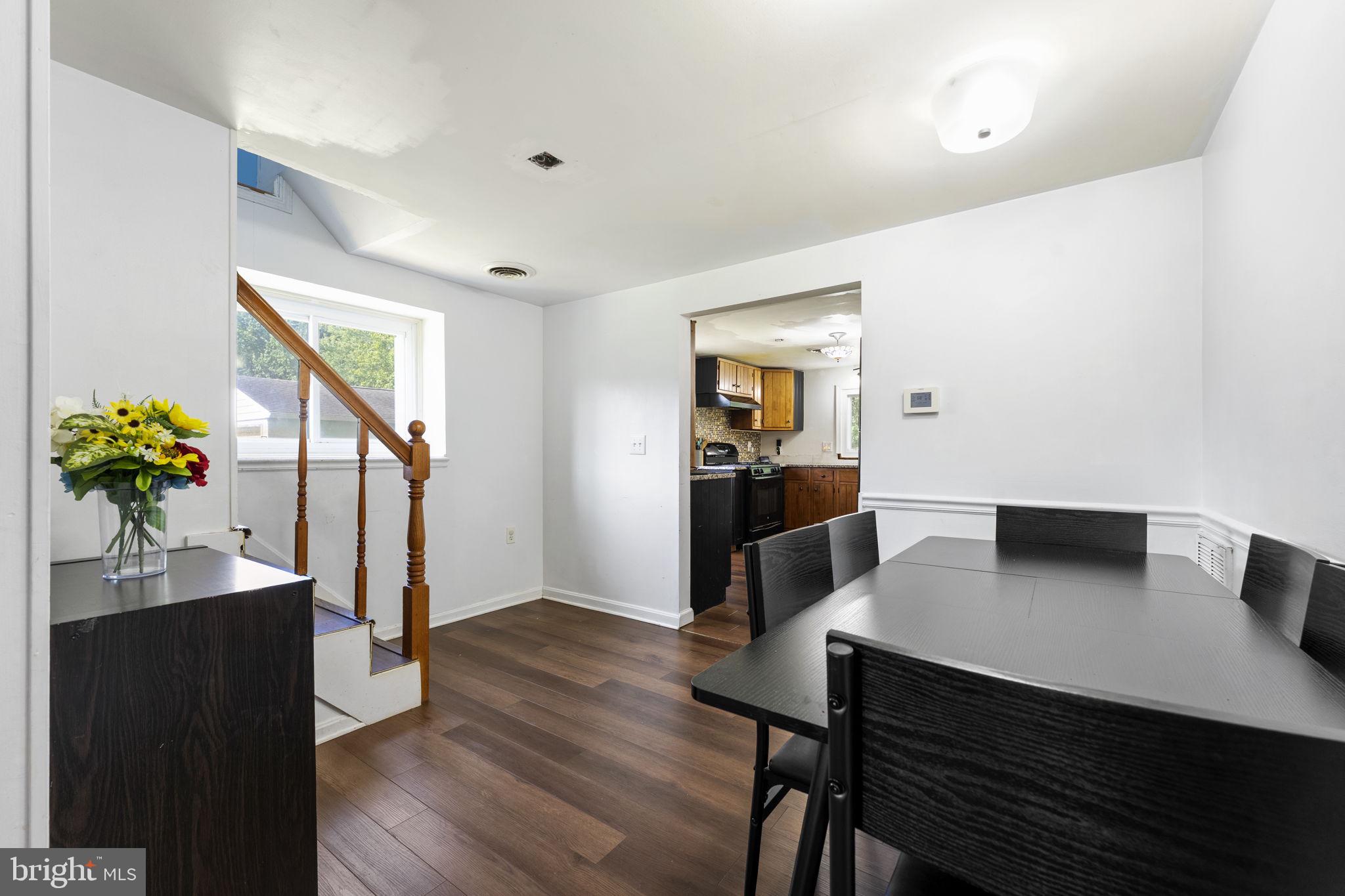 5087 Wheatleys Pond Road Smyrna, DE 19977 - Photo 4 of 36 a view of a dining room with furniture and wooden floor