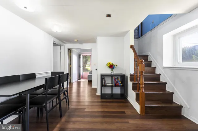 a view of entryway and hall with wooden floor