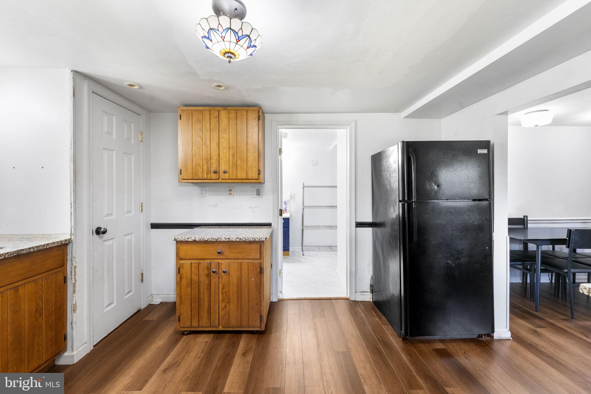 5087 Wheatleys Pond Road Smyrna, DE 19977 - Photo 9 of 36 a kitchen with a refrigerator and a stove top oven