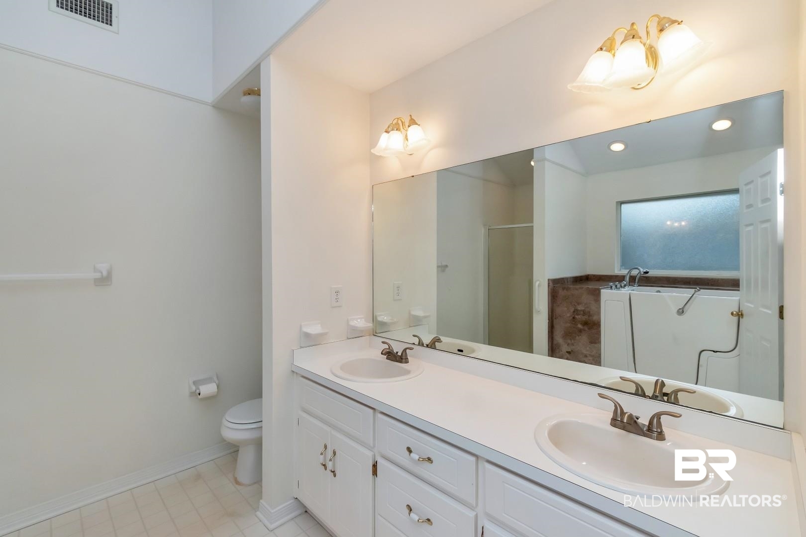 10006 Wedgefield Court Mobile, AL 36608 - Photo 16 of 34 Bathroom featuring double vanity, a sink, and visible vents