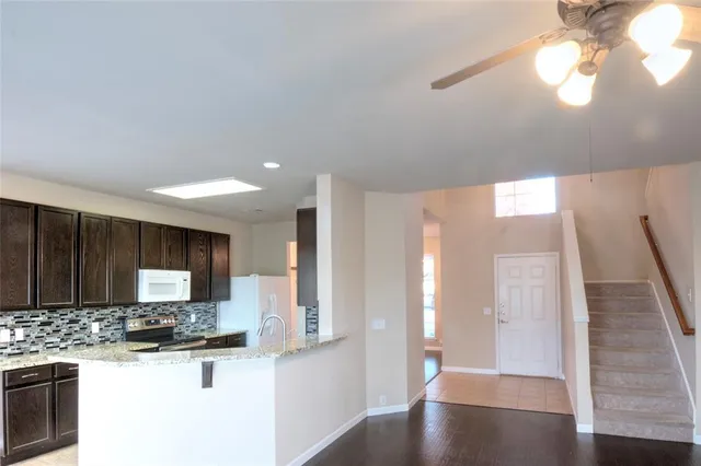a view of a kitchen with a sink and a refrigerator