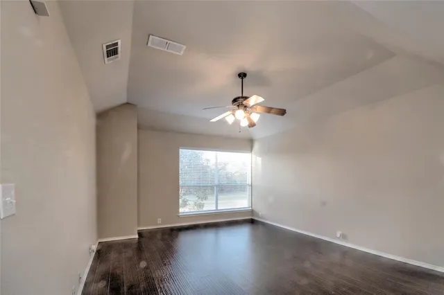 a view of room with a ceiling fan and window